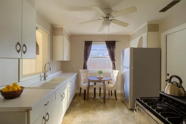 a spacious bathroom with a double vanity sink and a mirror