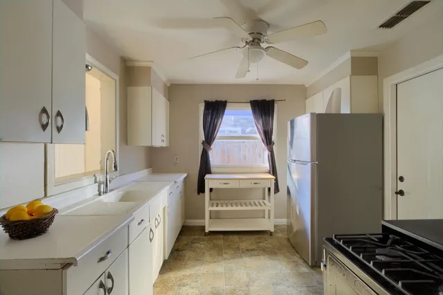 a kitchen with a sink and a stove top oven