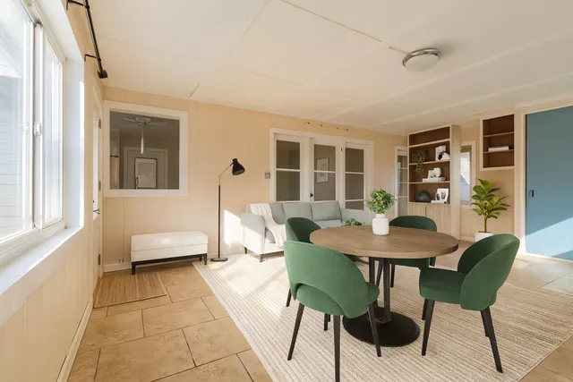 a view of a dining room with furniture and window