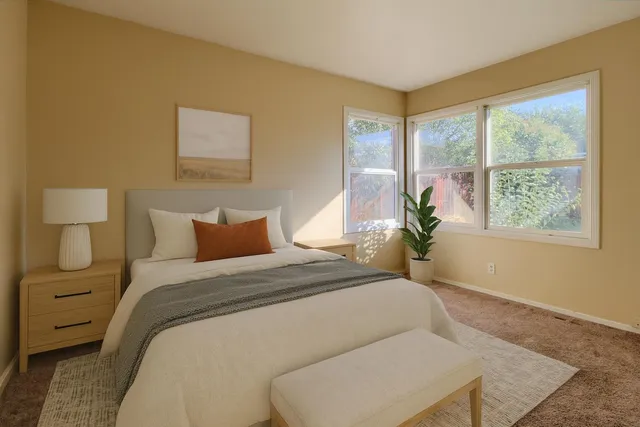 a bedroom with a large bed and a window