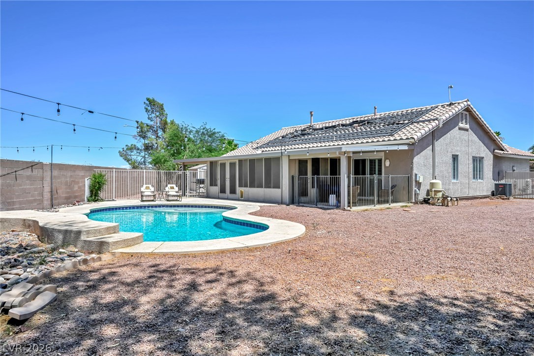 1234 Sunfire Street Henderson, NV 89014 - Photo 32 of 40 An inviting in-ground pool graces this home's spacious backyard, ready for recreation.