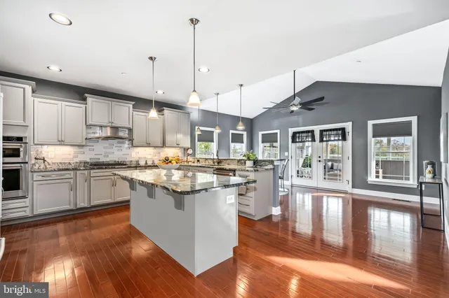a bedroom with a bed and ceiling fan