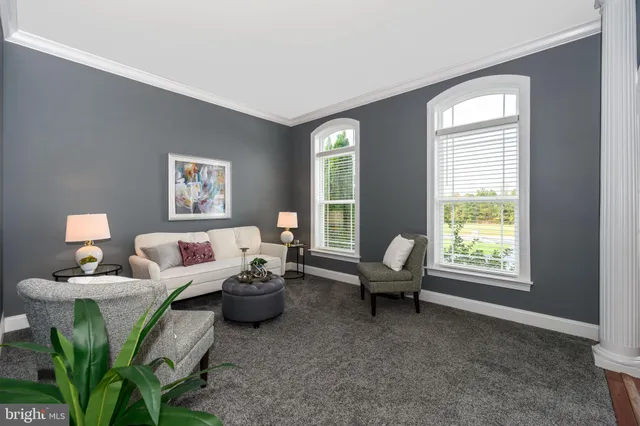 a view of a livingroom with workspace and a window