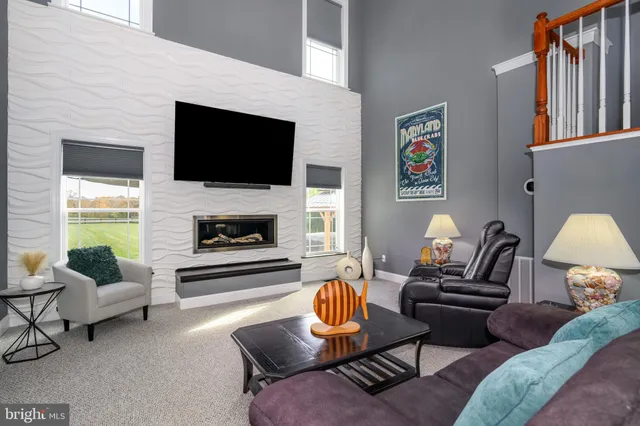 a kitchen with granite countertop a stove top oven a sink dishwasher a dining table and chairs with wooden floor