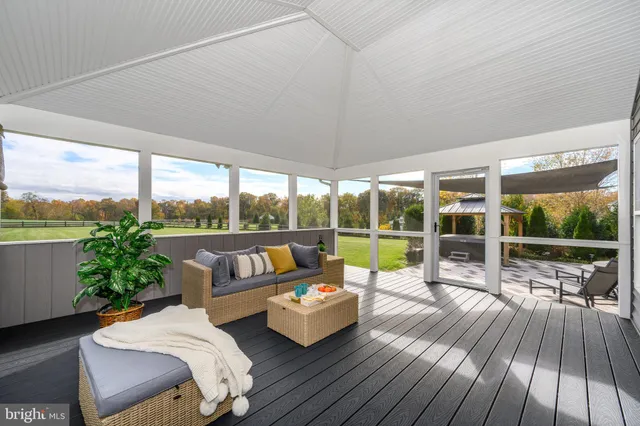 a kitchen with stainless steel appliances granite countertop a refrigerator a stove top oven a sink dishwasher a dining table and chairs with wooden floor