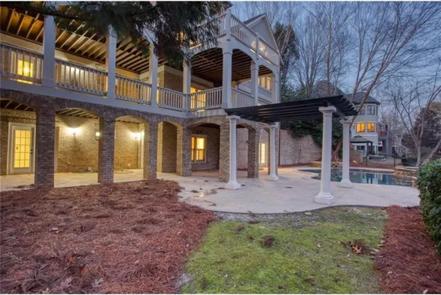 an aerial view of a house with a yard basket ball court and outdoor seating