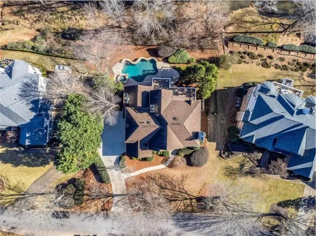 a view of a house with swimming pool and sitting area