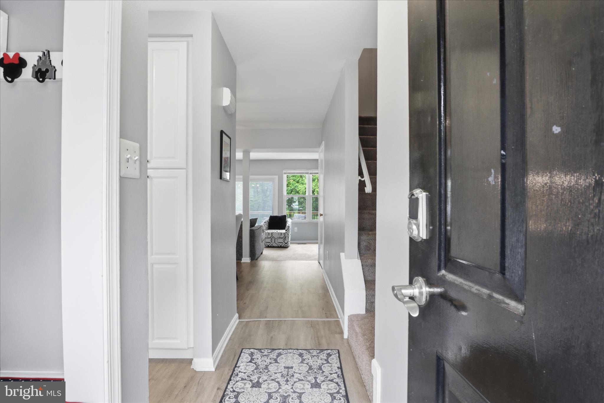 71 Kinsman View Circle Silver Spring, MD 20901 - Photo 8 of 42 a view of a hallway with a livingroom and a dinning room with chandelier