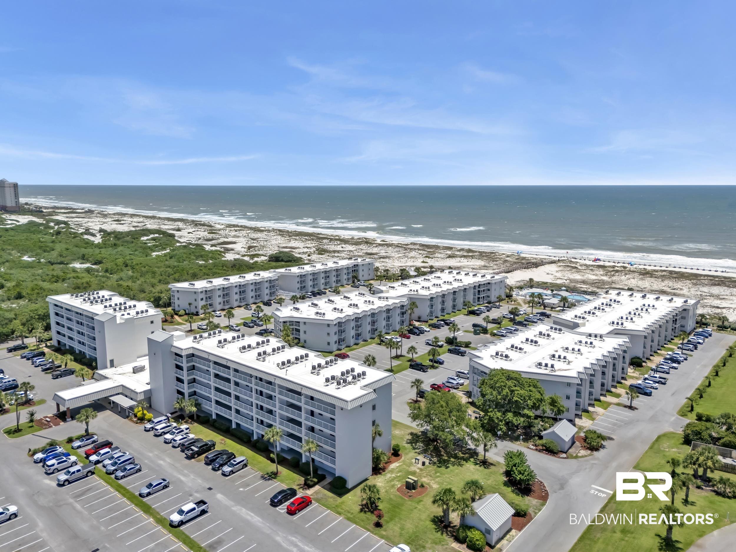 400 Plantation Road, Unit 2118 Gulf Shores, AL 36542 - Photo 58 of 59 Coastal multi-building property featuring ample surface parking, direct beach proximity, mature landscaping, and a central swimming pool