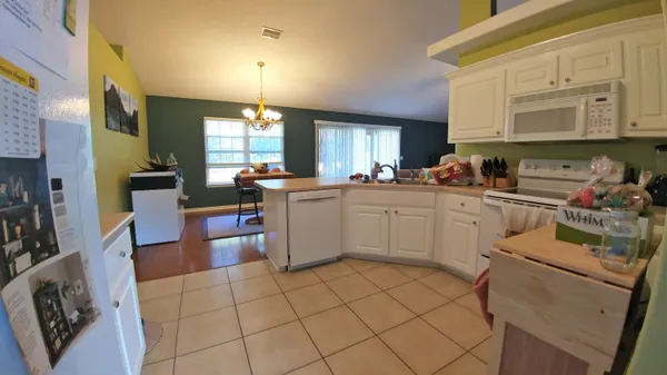 a kitchen with a sink window and cabinets