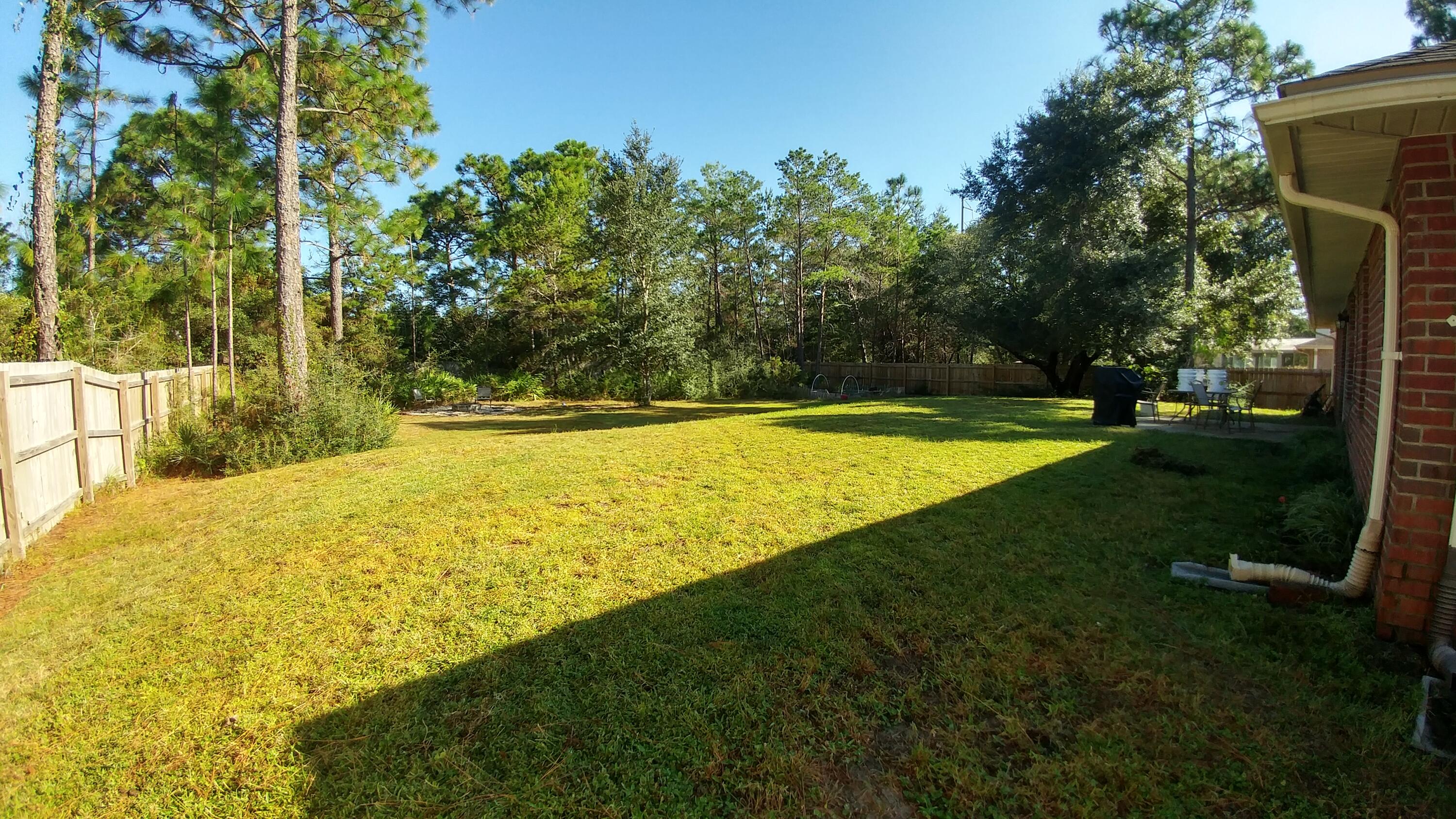 6568 Fern Street Navarre, FL 32566 - Photo 7 of 10 a view of a swimming pool with an outdoor space and seating area