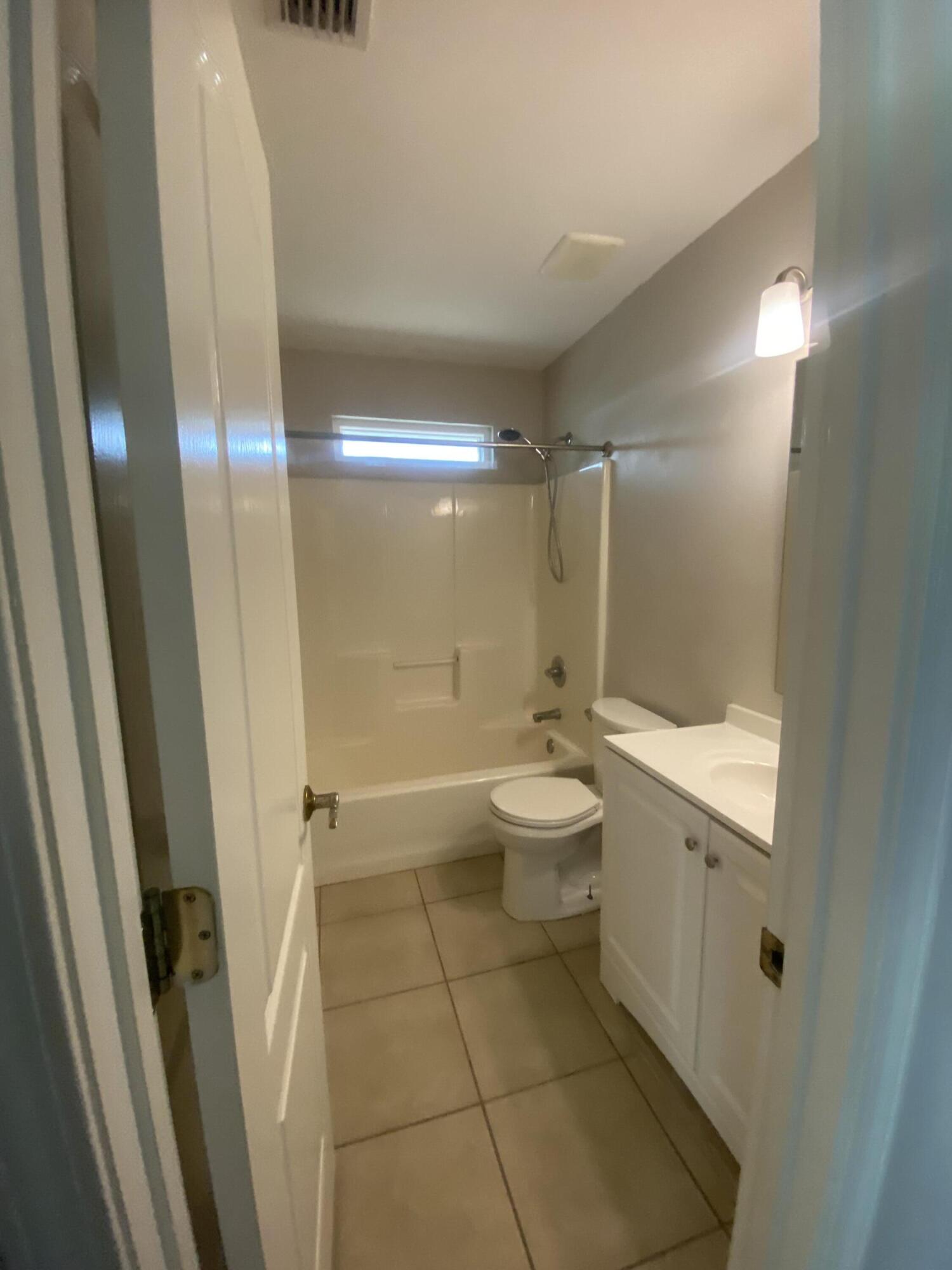 6568 Fern Street Navarre, FL 32566 - Photo 9 of 10 a bathroom with a double vanity sink toilet and shower