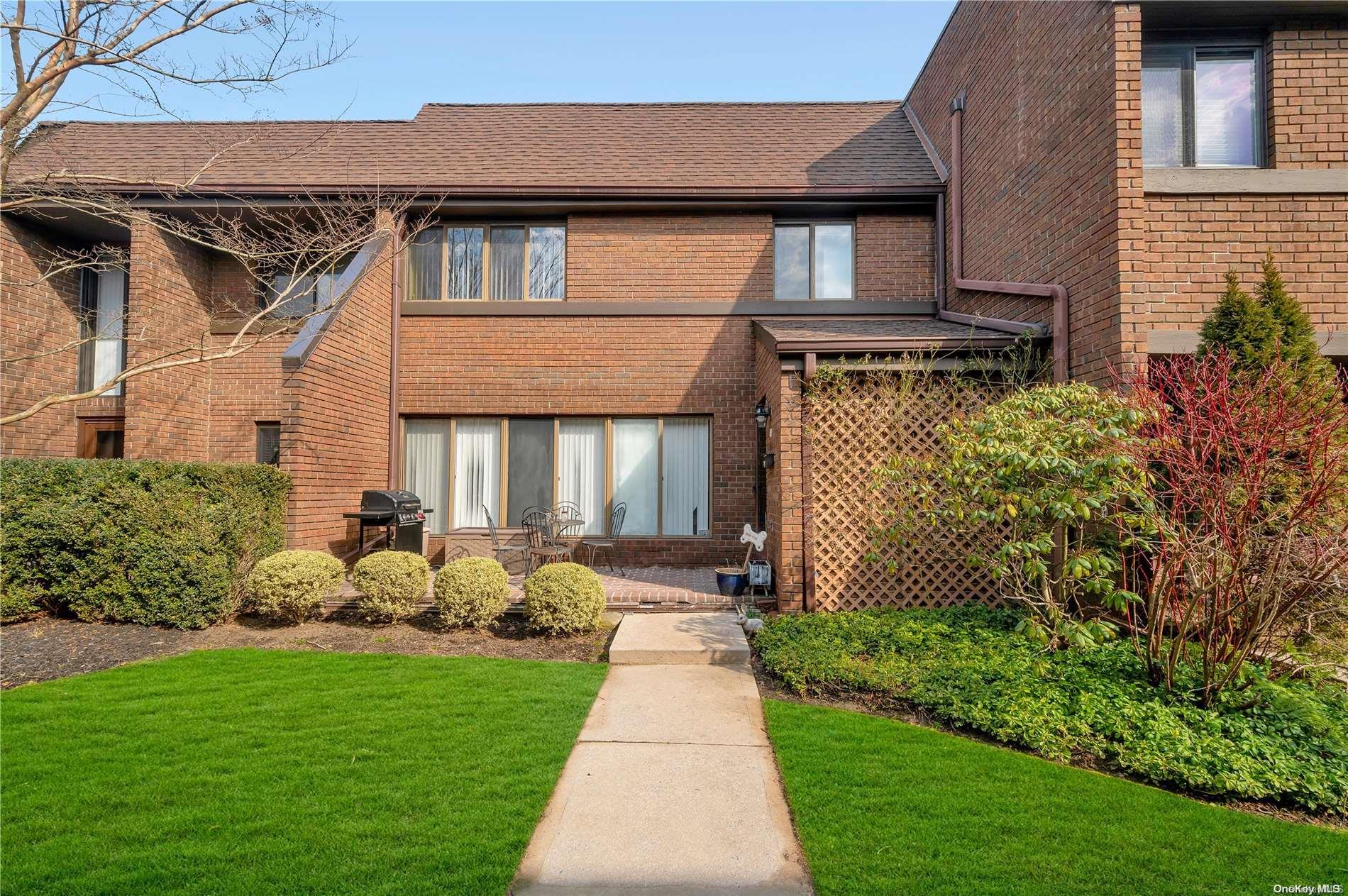 40 Spring Hollow Road, Unit 32 Roslyn, NY 11576 - Photo 1 of 1 a front view of a house with garden