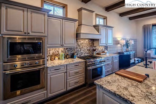 2001 Moon Run Linville, NC 28646 - Photo 7 of 33 a kitchen with stainless steel appliances granite countertop a stove top oven a sink dishwasher and cabinets with wooden floor