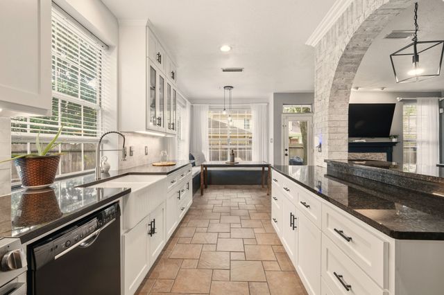a large kitchen with a sink and large stove