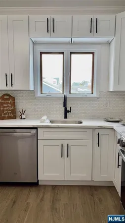 a kitchen with white cabinets and a sink