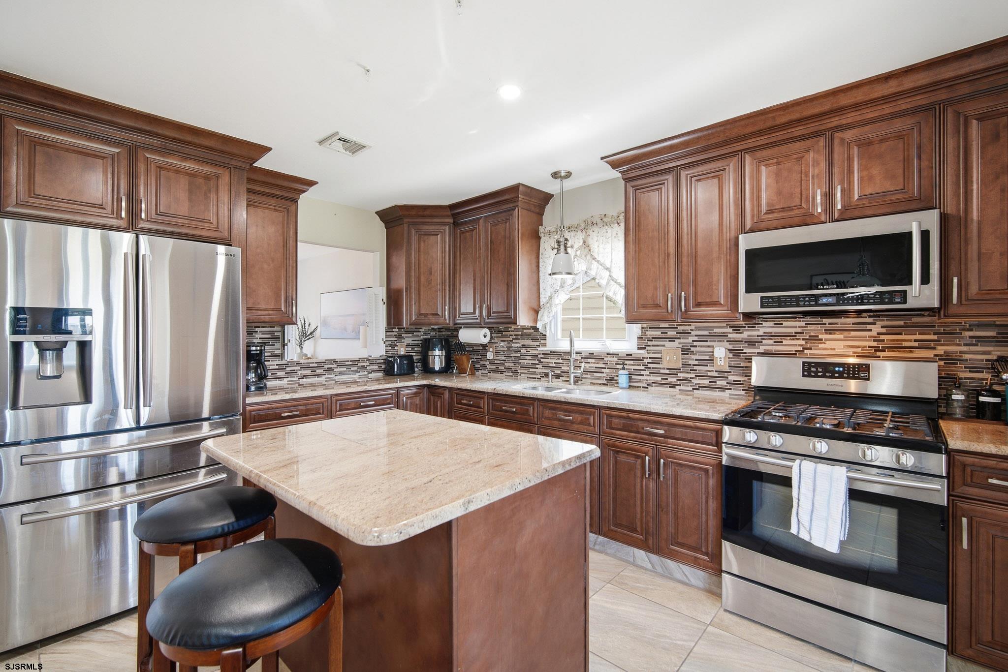 214 Hagen Road Brigantine, NJ 08203 - Photo 13 of 34 a kitchen with a stove a sink and a refrigerator