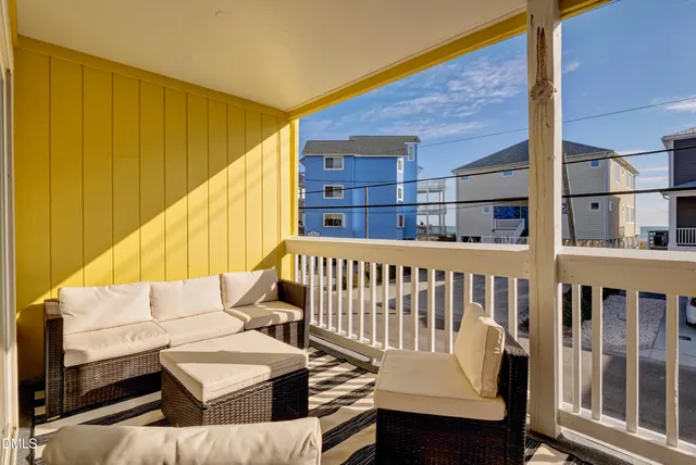 a balcony with wooden floor and furniture