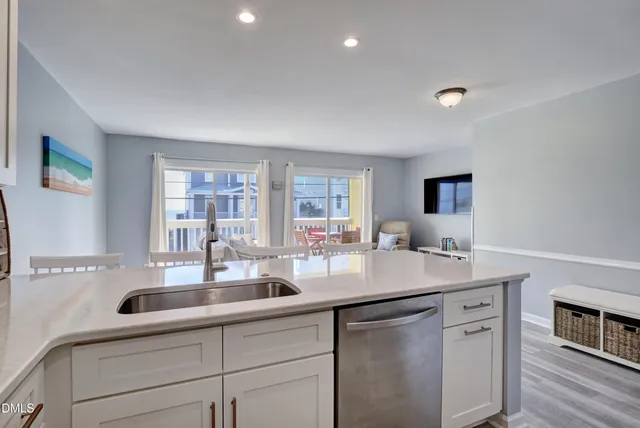 a kitchen with stainless steel appliances granite countertop a sink and dishwasher with wooden floor