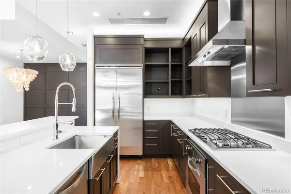 a kitchen with a sink cabinets and stainless steel appliances