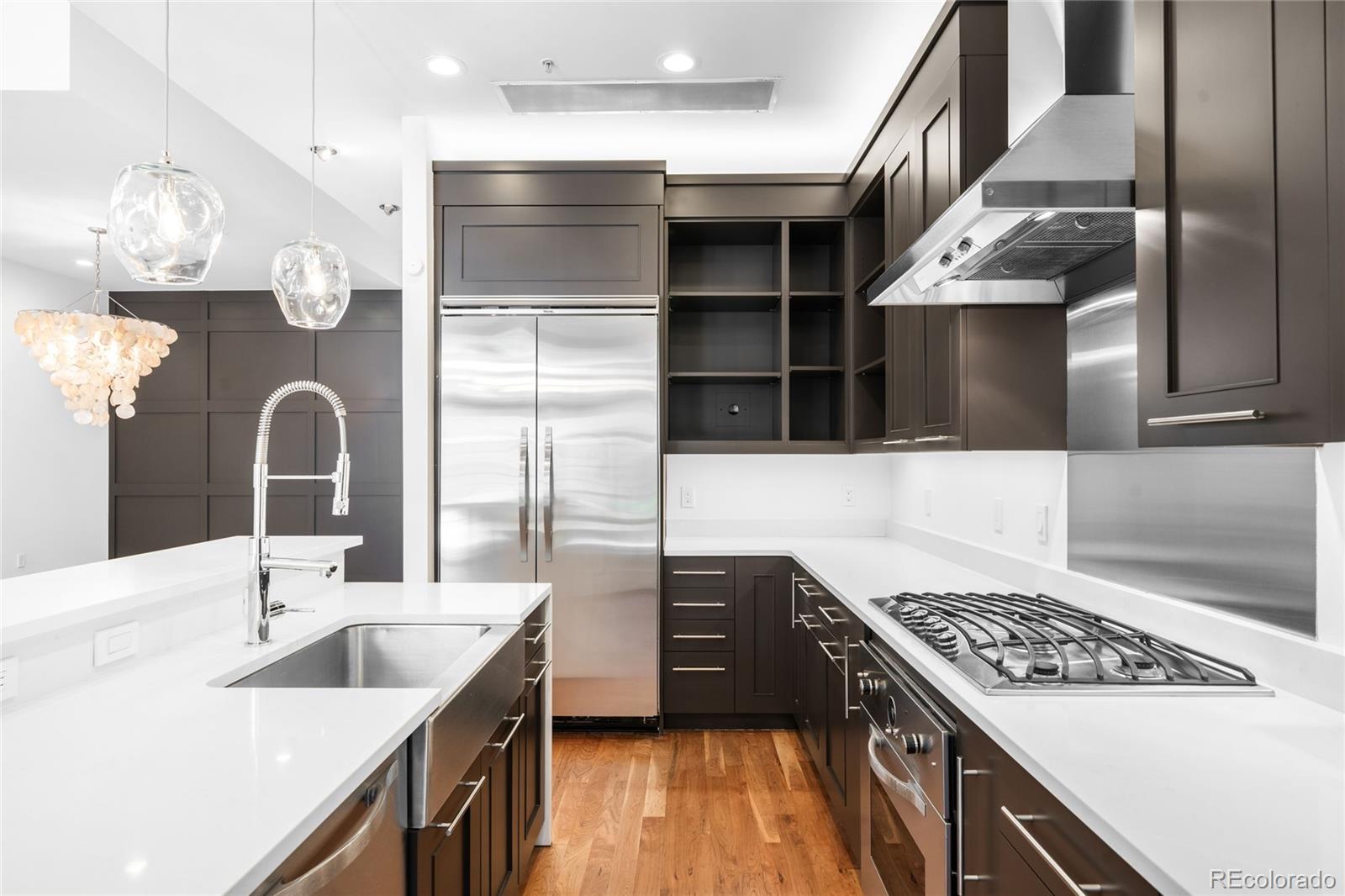 2133 18th Street, Unit RL Denver, CO 80202 - Photo 12 of 46 a kitchen with a sink cabinets and stainless steel appliances