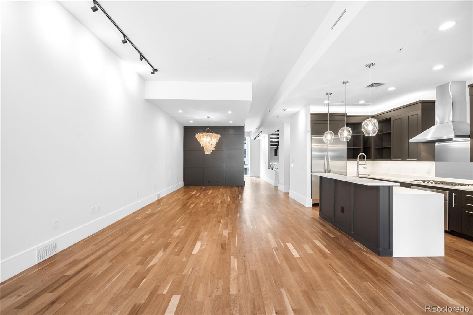 2133 18th Street, Unit RL Denver, CO 80202 - Photo 16 of 46 a view of kitchen with cabinets and wooden floor