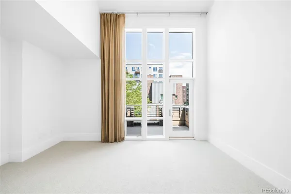 an empty room with a fireplace and a window