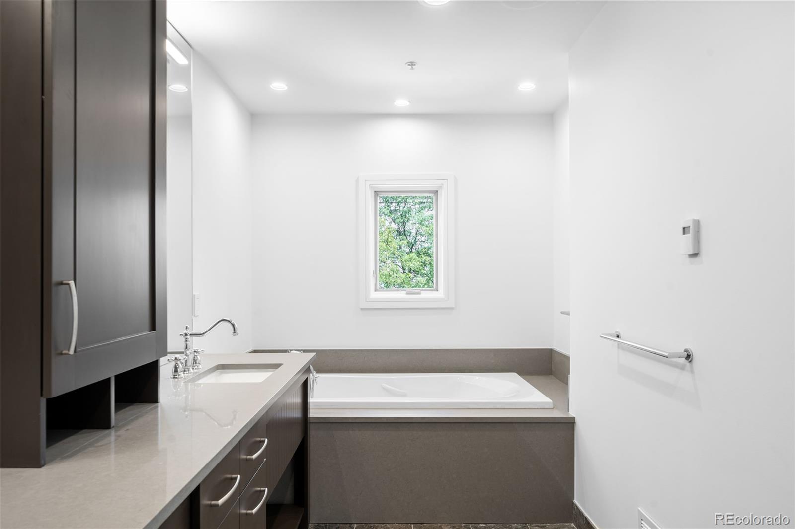 2133 18th Street, Unit RL Denver, CO 80202 - Photo 21 of 46 a bathroom with a sink a toilet and a tub