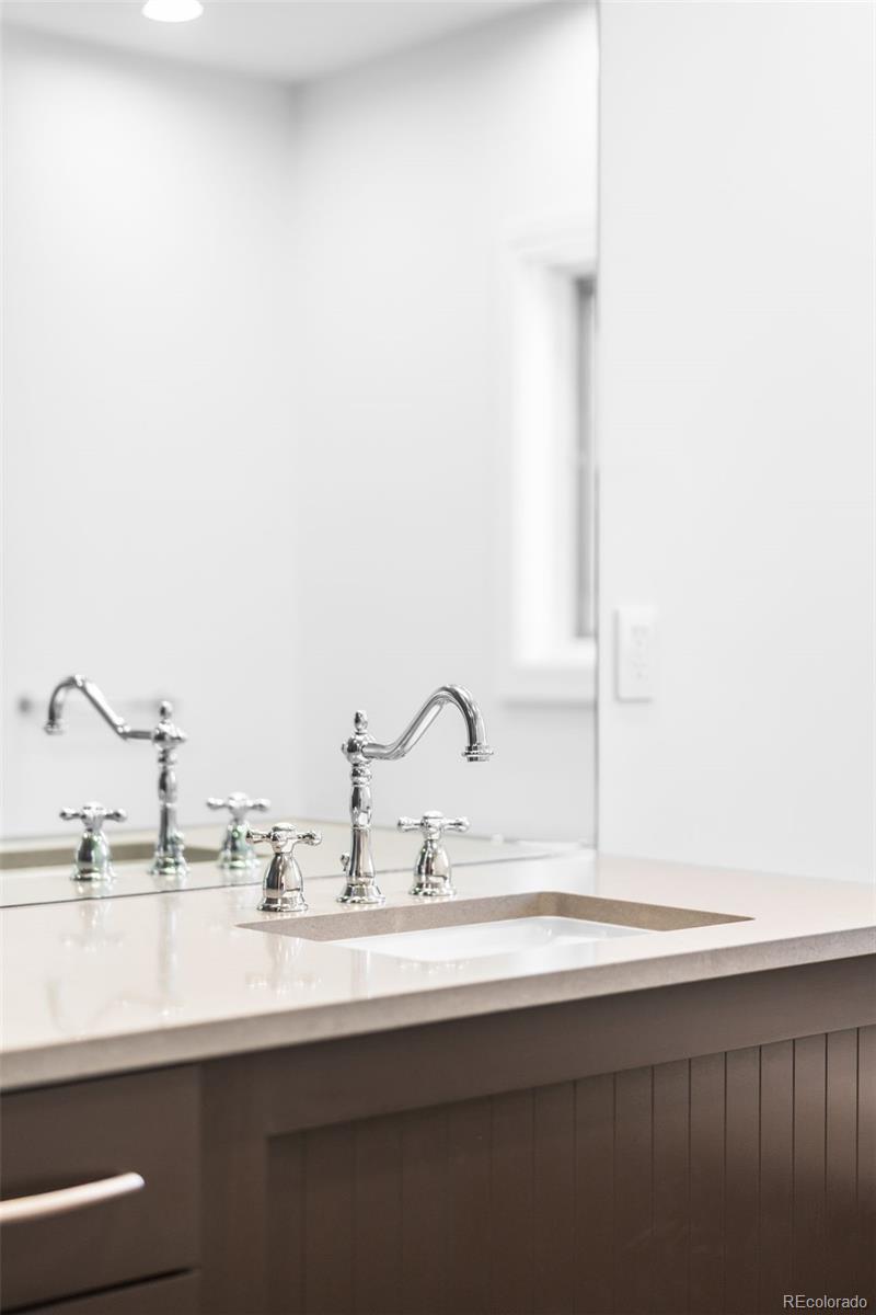 2133 18th Street, Unit RL Denver, CO 80202 - Photo 24 of 46 a bathroom with a sink and a mirror