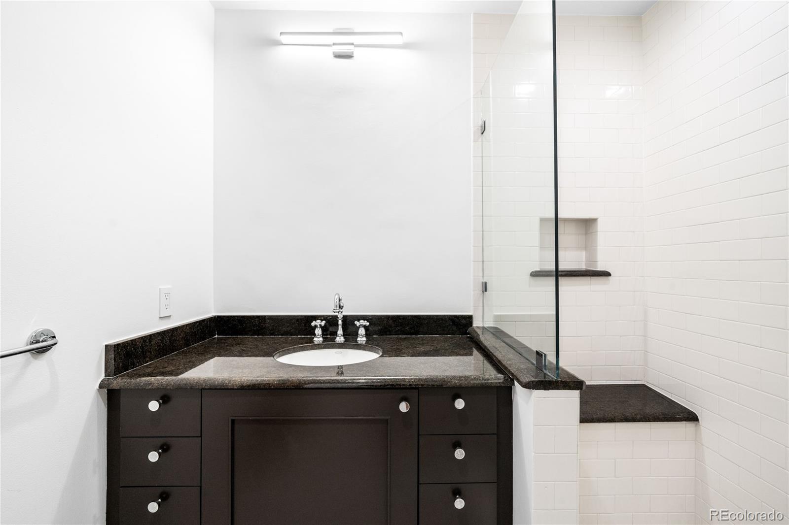 2133 18th Street, Unit RL Denver, CO 80202 - Photo 29 of 46 a bathroom with a sink and a mirror