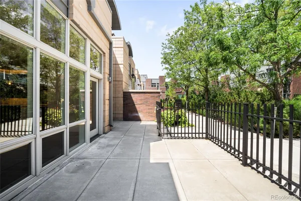a view of a balcony with a floor to ceiling window and wooden fence