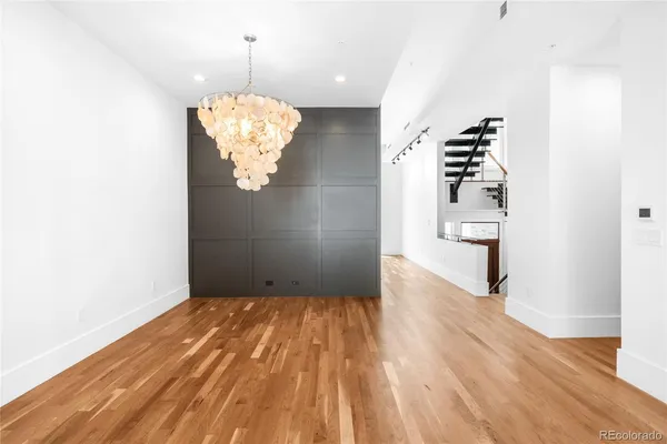 a view of a chandelier fan and wooden floor
