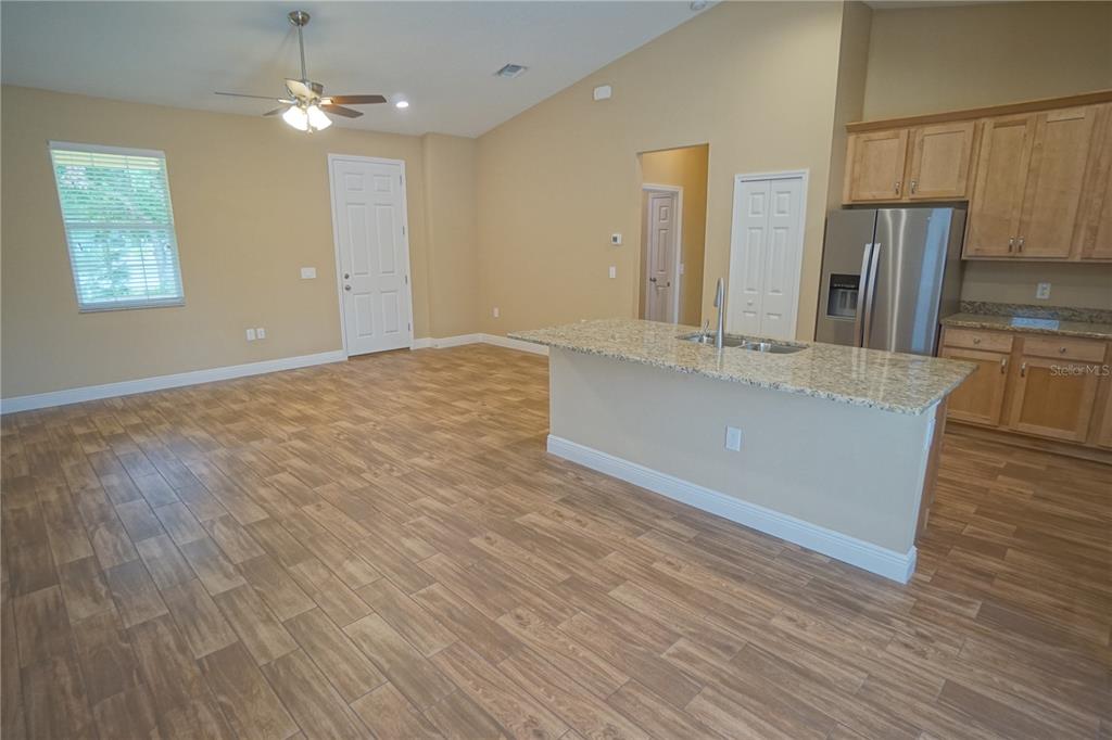 3525 West Ballast Point Boulevard Tampa, FL 33611 - Photo 17 of 25 a view of a kitchen with a sink dishwasher refrigerator stove and wooden floor
