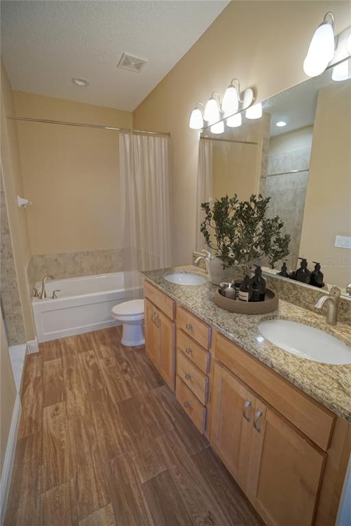 3525 West Ballast Point Boulevard Tampa, FL 33611 - Photo 7 of 25 a bathroom with a double vanity sink and a toilet