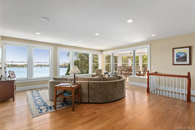 a dining room with furniture a chandelier and wooden floor
