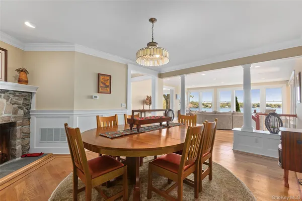 a dining room with furniture a chandelier and wooden floor