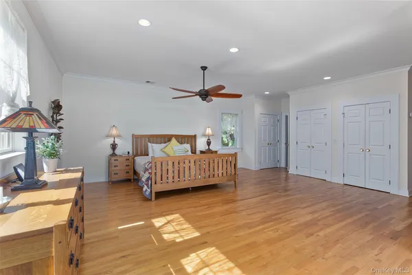 a view of a livingroom with furniture wooden floor and windows
