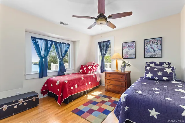 a bedroom with a bed a window and a chandelier