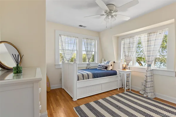 a bedroom with a bed and wooden floor