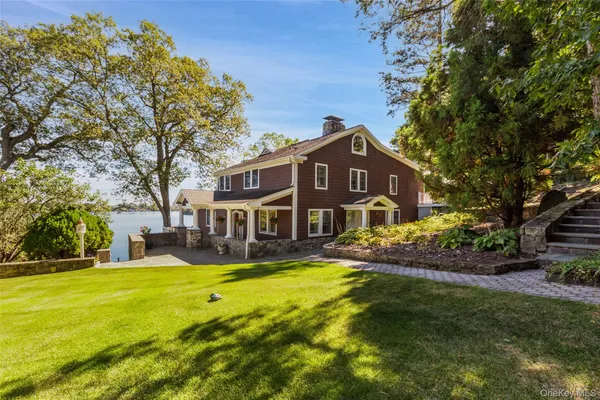 a view of a house with a yard patio and fire pit