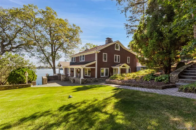 a view of a house with a yard patio and fire pit