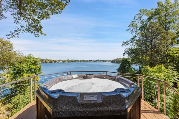 a view of a swimming pool with lawn chairs and a yard