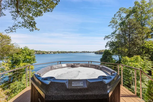 a view of a swimming pool with lawn chairs and a yard