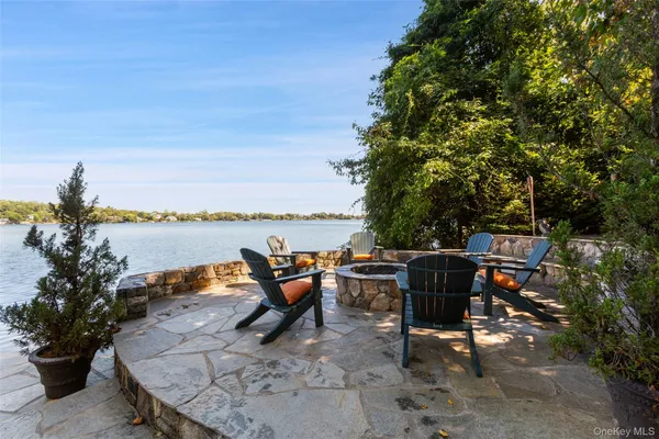 a view of a house with a big yard and large trees