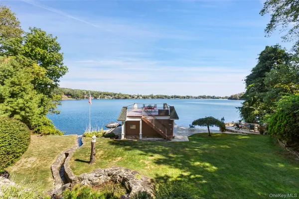 a view of a lake with a table and chairs