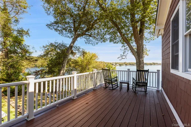 a view of balcony with wooden floor and seating space