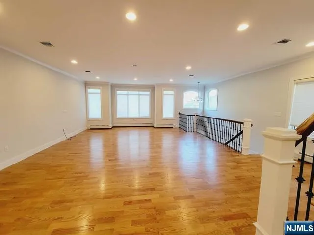 a view of a room with wooden floor