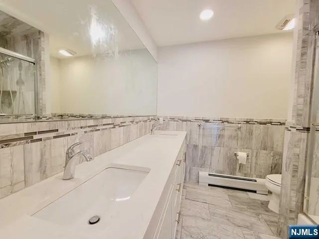 a spacious bathroom with a tub and a sink