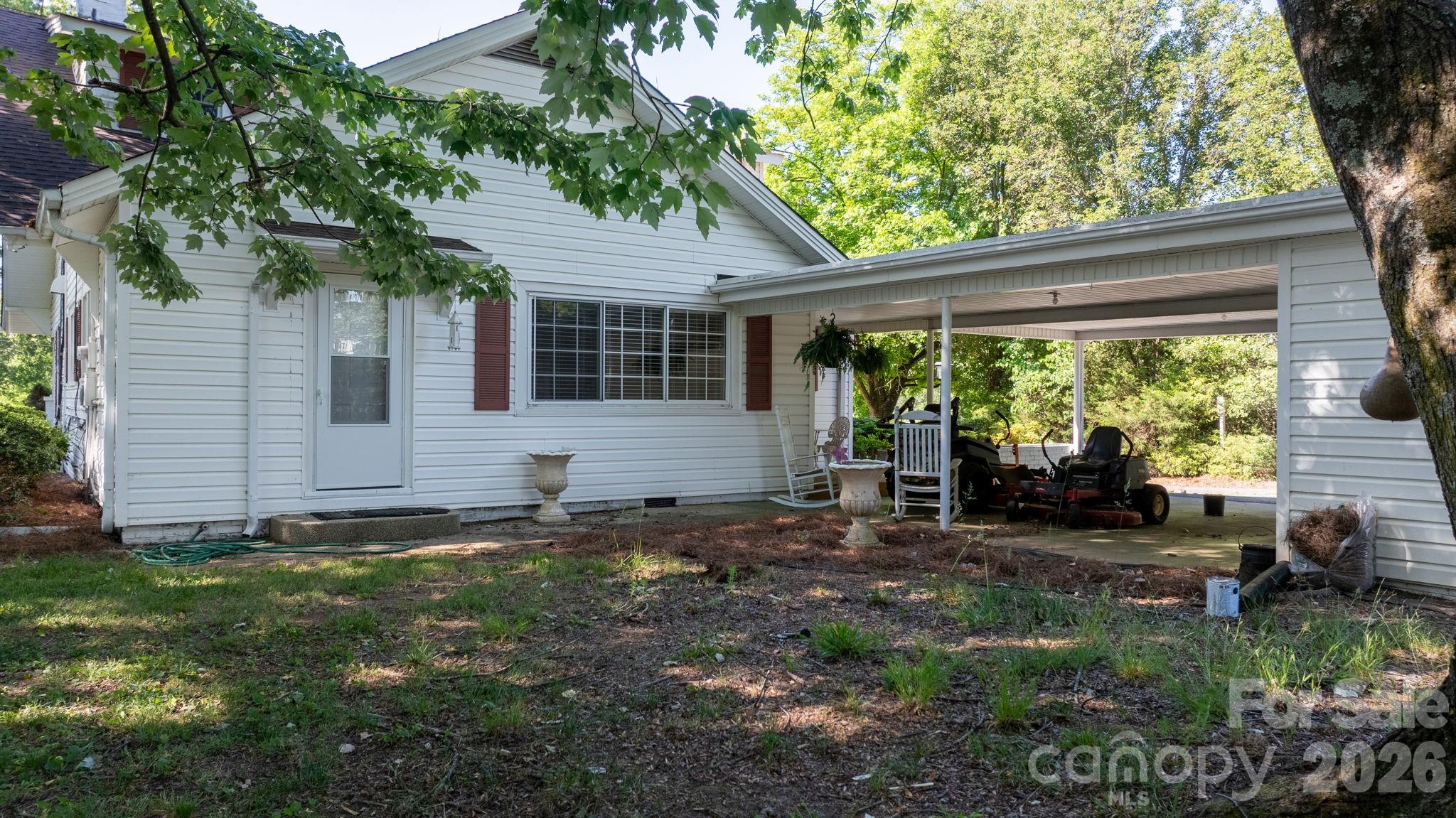 144 Hunter Bridge Road Stony Point, NC 28678 - Photo 34 of 45 a view of a house with backyard sitting area and garden