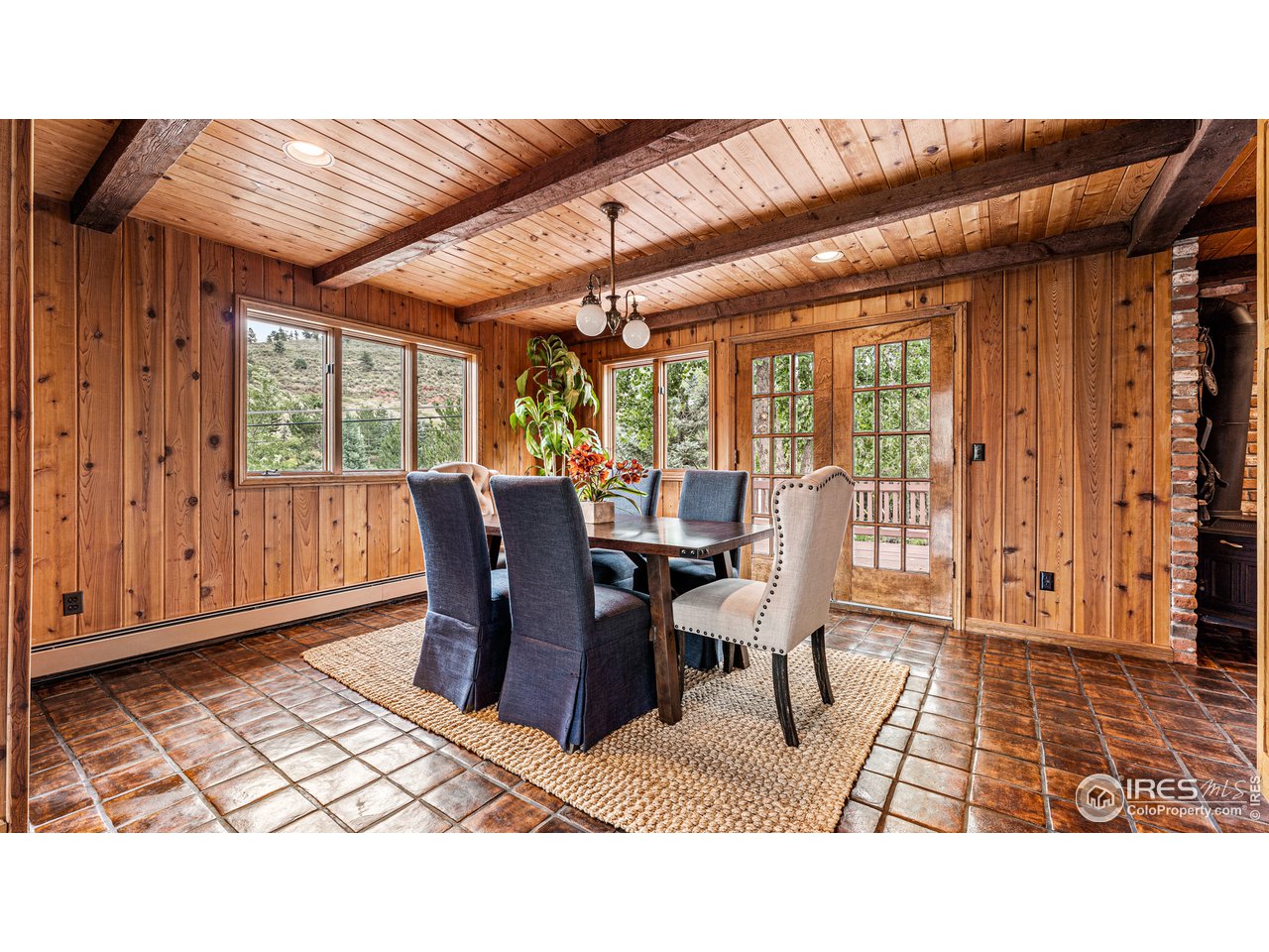7333 Olde Stage Road Boulder, CO 80302 - Photo 11 of 40 a dining room with furniture a chandelier and wooden floor